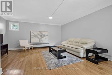Burlington (Brant) multi-family for rent - A living room with a white sofa and a wooden floor.