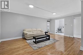 Burlington (Brant) multi-family for rent - A living room with a white couch and a coffee table.