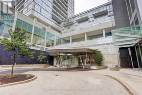 Toronto (Willowdale West) condo for rent - A modern building with a glass facade and a tree in front.