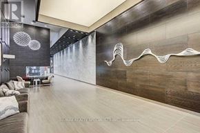 Toronto (Willowdale West) condo for rent - A modern living room with a grey couch and a wooden wall.