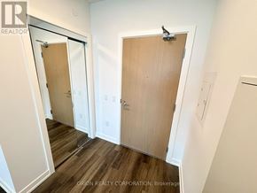 Vaughan (Vaughan Corporate Centre) condo for rent - A hallway with three doors and a brokerage sign.