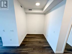 Vaughan (Vaughan Corporate Centre) condo for rent - A room with white walls and wood flooring.
