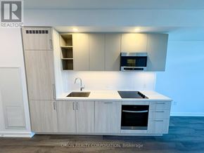 Vaughan (Vaughan Corporate Centre) condo for rent - A kitchen with a sink, stove, and cabinets.
