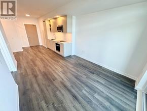 Vaughan (Vaughan Corporate Centre) condo for rent - A spacious room with wood flooring and white walls.