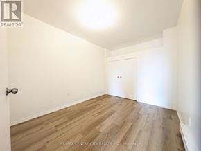 St. Thomas multi-family for rent - A room with a wooden floor and white walls, with a door at the end of the room.