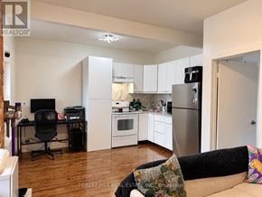 Toronto (Weston-Pellam Park) multi-family for rent - A kitchen with a refrigerator, oven, and microwave.