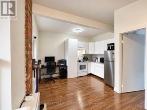 Toronto (Weston-Pellam Park) multi-family for rent - A kitchen area with a refrigerator, microwave, and oven.