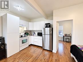 Toronto (Weston-Pellam Park) multi-family for rent - A kitchen with a refrigerator, oven, and microwave.