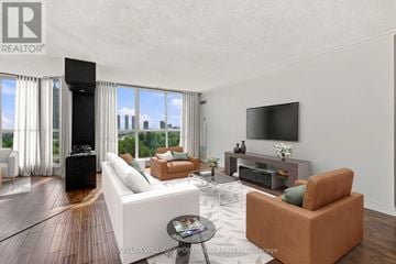 Toronto (High Park-Swansea) condo for rent - A living room with a white couch and a television on the wall.