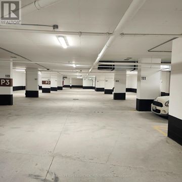 Milton (Tm Timberlea) condo for rent - A parking garage with a white car parked in spot 111.