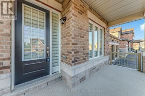 Otonabee-South Monaghan apartment for rent - A house entrance with a black door and a brick pillar.