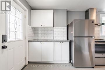 Toronto (O'connor-Parkview) apartment for rent - A kitchen with white cabinets and a stainless steel refrigerator.