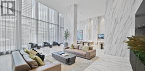 Mississauga (City Centre) condo for rent - A living room with a couch, a coffee table, and a TV.