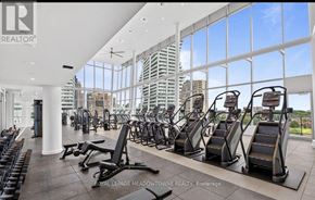 Mississauga (City Centre) condo for rent - A gym with a row of treadmills and a row of stationary bikes.