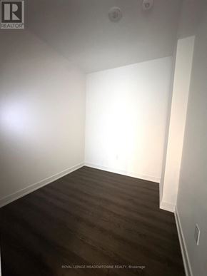 Mississauga (City Centre) condo for rent - A room with white walls and dark wood flooring.