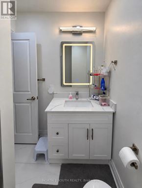 Toronto (Black Creek) apartment for rent - A bathroom with a sink, mirror, and medicine cabinet.