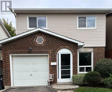 Brampton (Westgate) apartment for rent - A house with a white garage door and a brick facade.