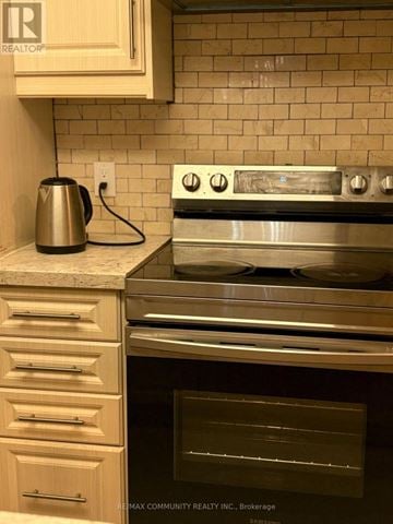 Toronto (Dorset Park) condo for rent - A modern kitchen with a stainless steel oven and a kettle on the counter.