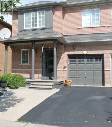 Milton (De Dempsey) apartment for rent - A house with a grey garage door and a black driveway.