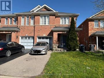 Brampton (Fletcher's Meadow) apartment for rent - A house with a car parked in front of it.
