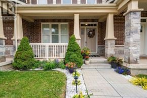 Oakville (Go Glenorchy) townhouse for rent - A house numbered 3355 with a front yard and a small garden.