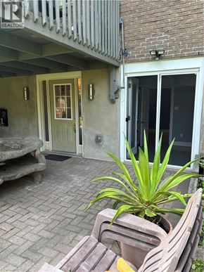 Kitchener apartment for rent - A patio with a bench and a potted plant.