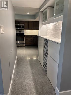 Kitchener apartment for rent - A long hallway with a kitchen area at the end.