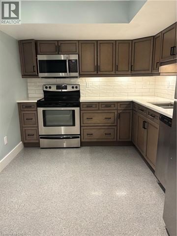 Kitchener apartment for rent - A kitchen with a stove top oven and microwave.