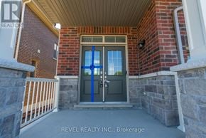 Whitby (Rolling Acres) townhouse for rent - A house entrance with a blue door and a sign that says REVEL REALTY N.C. Brokerage.
