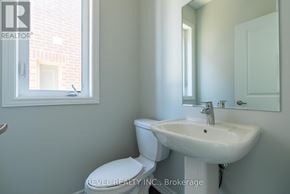Whitby (Rolling Acres) townhouse for rent - A white toilet sits next to a white sink in a bathroom.