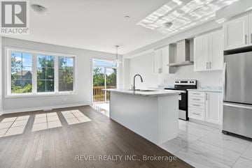 Whitby (Rolling Acres) townhouse for rent - A modern kitchen with white cabinets and stainless steel appliances.