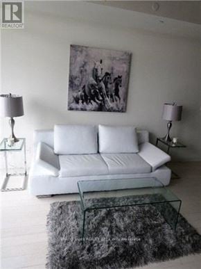 Toronto (Waterfront Communities) house for rent - A living room with a white couch and a grey rug.
