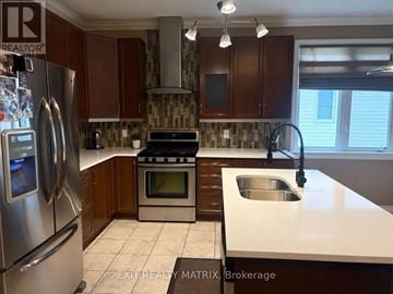 The Nation apartment for rent - A kitchen with a stove top oven and a refrigerator.