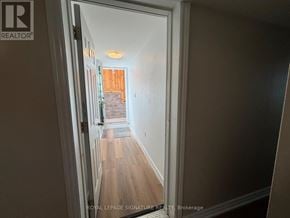 Toronto (Victoria Village) apartment for rent - A hallway with a doorway leading to a balcony.