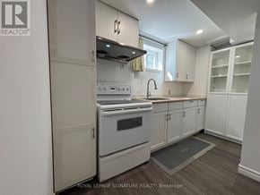 Toronto (Victoria Village) apartment for rent - A kitchen with a stove top oven and a sink.