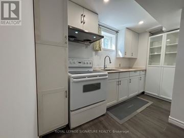 Toronto (Victoria Village) apartment for rent - A kitchen with a stove top oven and a sink.