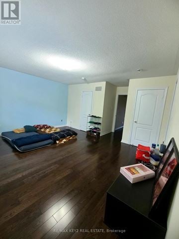 Pickering (Duffin Heights) apartment for rent - A living room with a blue couch and a black coffee table.