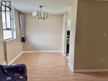 Toronto (Dorset Park) condo for rent - A living room with a couch and a chandelier.