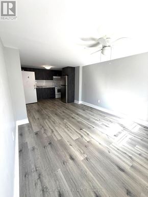 Toronto (Caledonia-Fairbank) multi-family for rent - A room with a ceiling fan and wooden flooring.