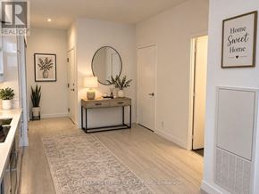Vaughan (Vaughan Corporate Centre) condo for rent - A modern kitchen with a white cabinet and a round mirror on the wall.
