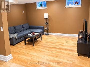Vaughan (Vellore Village) apartment for rent - A living room with a grey couch and a wooden floor.