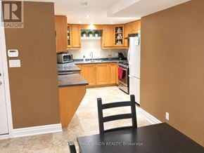 Vaughan (Vellore Village) apartment for rent - A kitchen with brown walls and a black counter top.