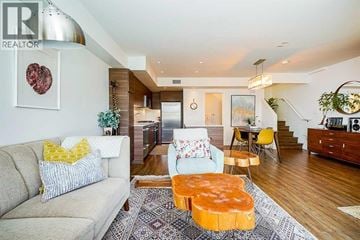 North Vancouver townhouse for rent - A living room with a couch, a coffee table, and a staircase.