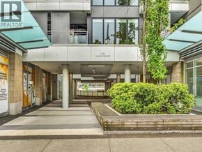 North Vancouver townhouse for rent - The entrance to a building with a green awning and a sign that says "REALTOR".