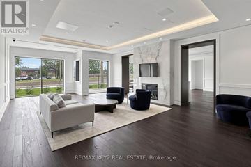 Toronto (Humber Heights) condo for rent - A modern living room with a large couch and a television.