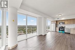 Toronto (Humber Heights) condo for rent - A spacious living room with a view of the cityscape outside the large windows.