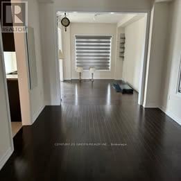 Brampton (Credit Valley) apartment for rent - A long hallway with a clock on the wall.