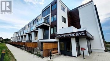 Toronto (Downsview-Roding-Cfb) townhouse for rent - A building with the sign "DOWNSVIEW PARK BLVD." in front of it.