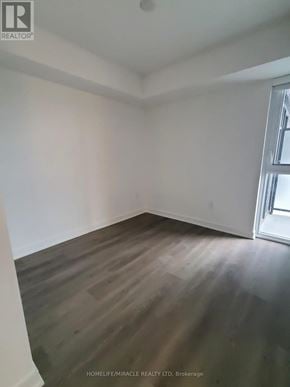 Toronto (Islington-City Centre West) condo for rent - A room with wooden flooring and a window.