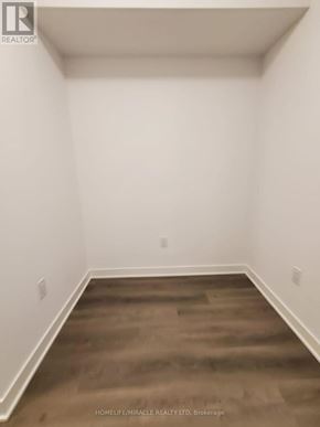Toronto (Islington-City Centre West) condo for rent - A room with white walls and wooden flooring.